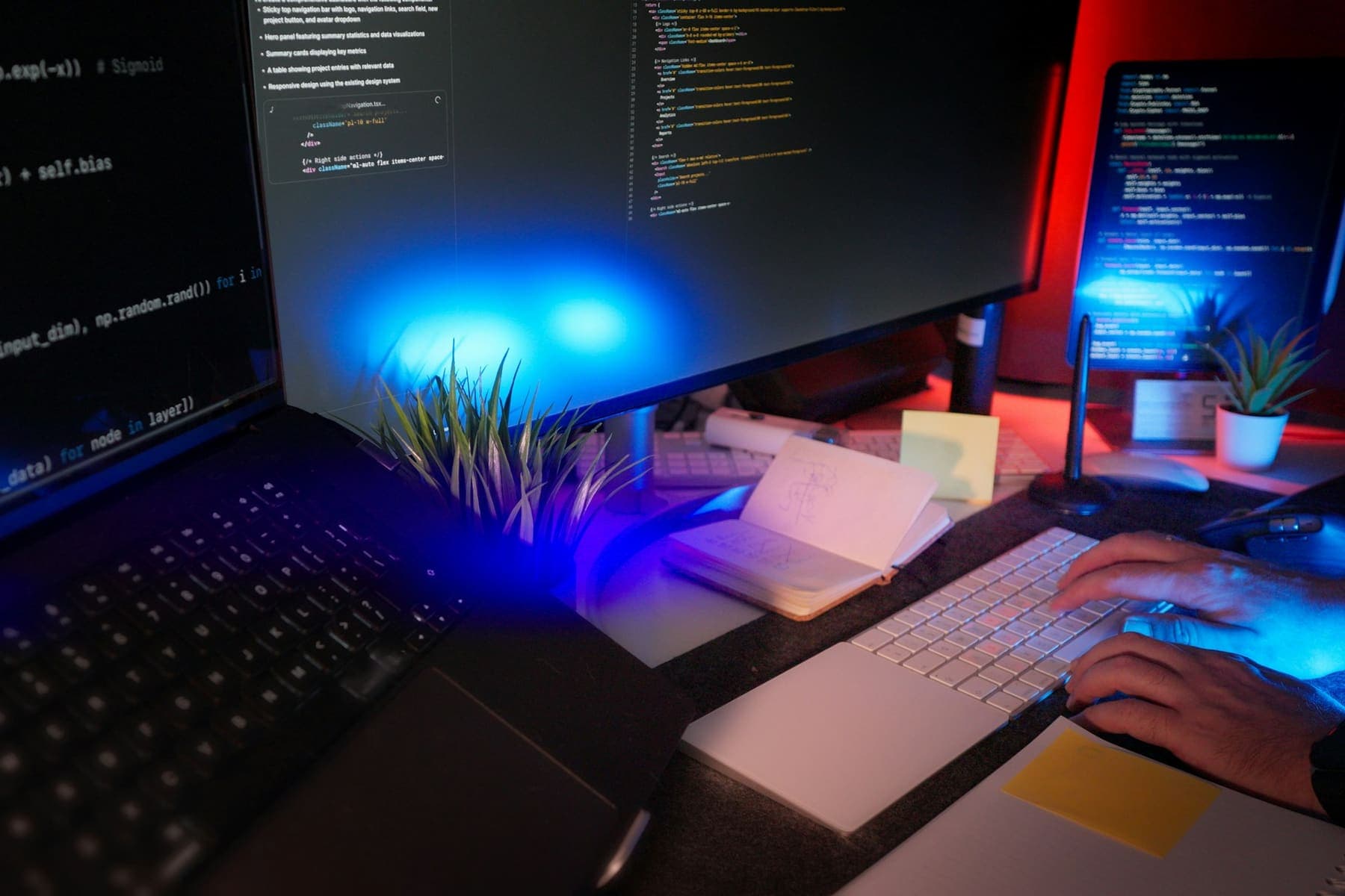 Developer workspace with code on multiple screens